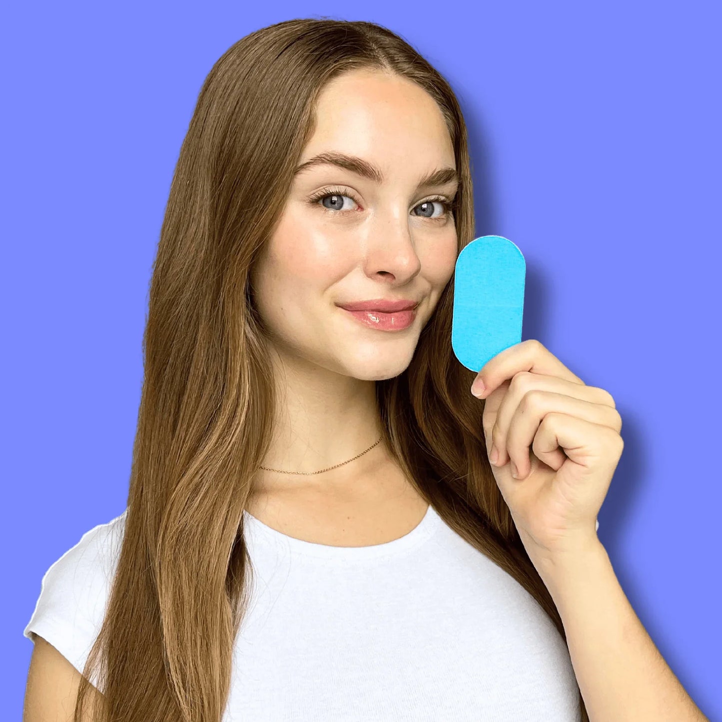 Woman holding a blue hypoallergenic mouth tape from the Mouth Tape Subscription - Mouth Tape 3 Month Supply | 90 Tapes, Free Shipping.
