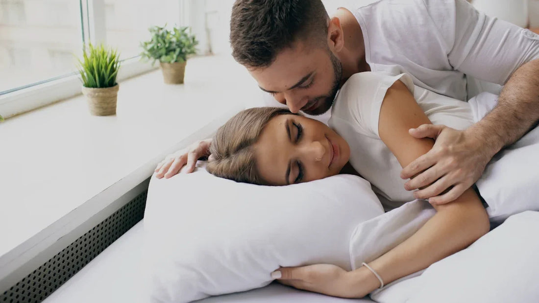Couple embracing tenderly in bed