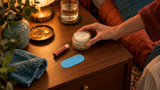 Solid8 light blue mouth tape beside moisturizer and lip balm on a walnut bedside table.